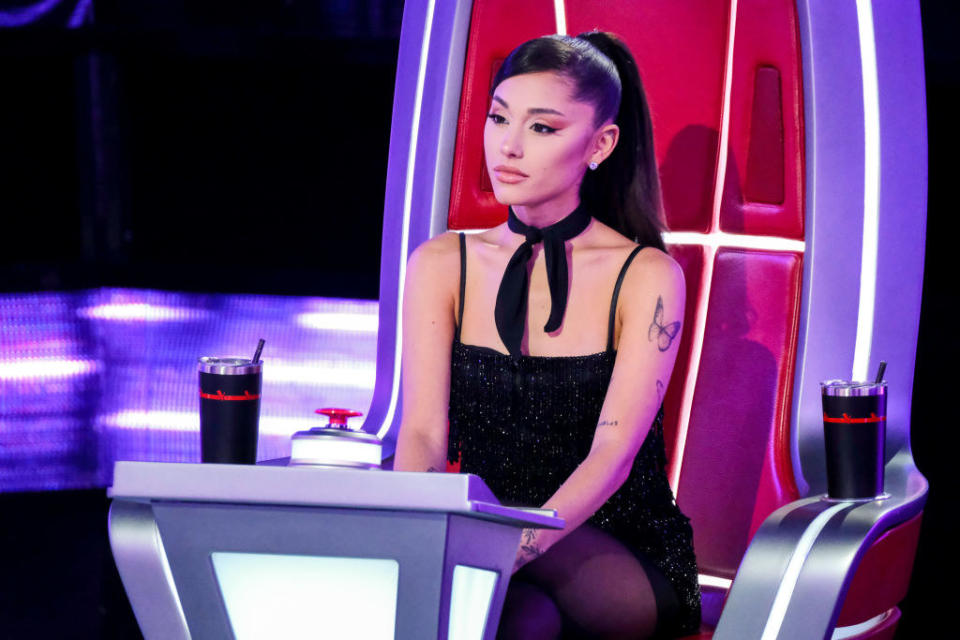 Ariana sitting on her judge's seat on The Voice