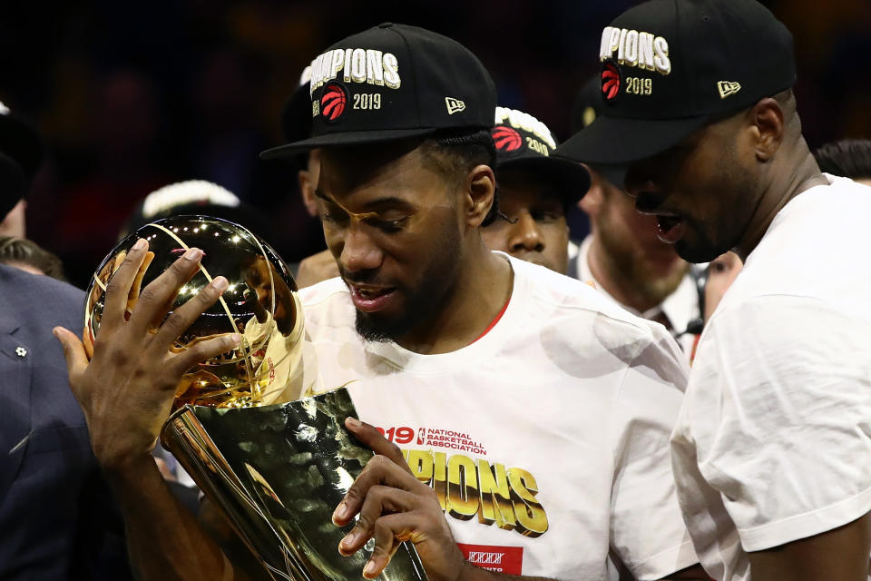 OAKLAND, CALIFORNIA - JUNE 13:  Kawhi Leonard #2 of the Toronto Raptors celebrates with the Larry O'Brien Championship Trophy after his team defeated the Golden State Warriors to win Game Six of the 2019 NBA Finals at ORACLE Arena on June 13, 2019 in Oakland, California. NOTE TO USER: User expressly acknowledges and agrees that, by downloading and or using this photograph, User is consenting to the terms and conditions of the Getty Images License Agreement. (Photo by Ezra Shaw/Getty Images)