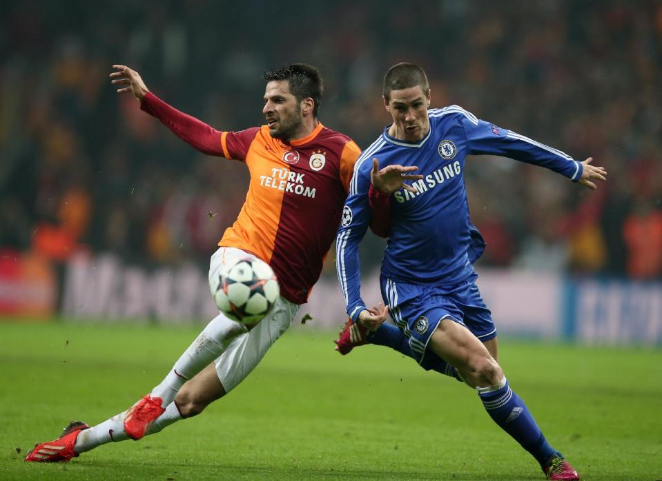 Hakan Balta of Galatasaray, left, and Fernando Torres of Chelsea fight for the ball during their Champions League Round of 16, First Leg soccer match between Galatasaray and Chelsea at Turk Telekom Arena Stadium in Istanbul, Turkey, Wednesday, Feb. 26, 2014. (AP Photo)