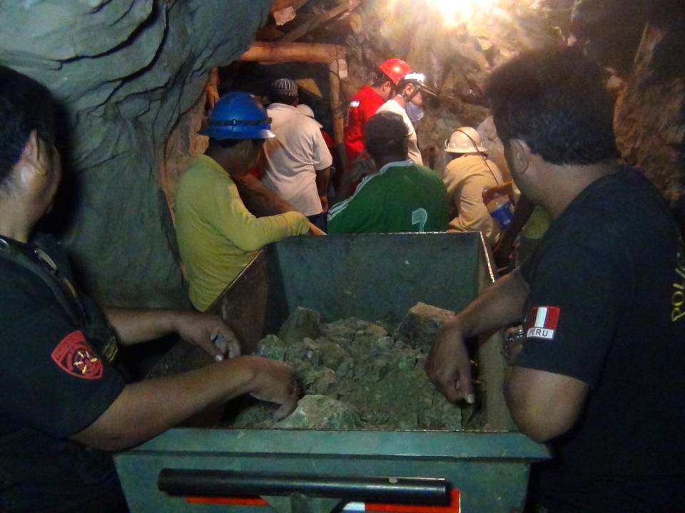 People work in a collapsed mine to rescue trapped miners in Ica, Peru, Saturday, April 7, 2012. According to Peruvians authorities, nine miners trapped since Thursday in a collapsed mine are being supplied with sports drinks, soup and food while police, firefighters and other workers work to free them. (AP Photo) PERU OUT - NO PUBLICAR EN PERU