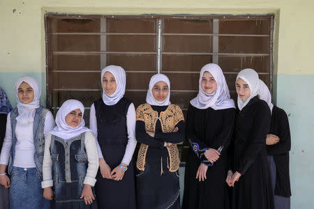 Pupils stand in from their classroom at an elementary school in eastern Mosul, Iraq, April 17, 2017. REUTERS/Marko Djurica