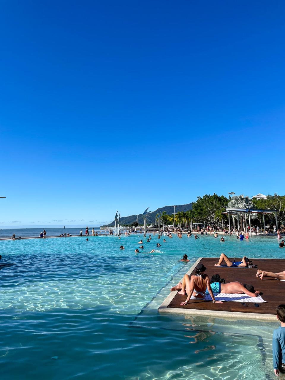 Australians and tourists at a community pool in Cairns, Australia.