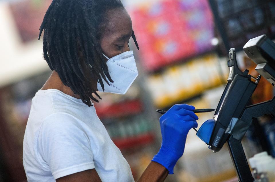 A customer wears a mask and gloves while shopping in Jackson, Miss.