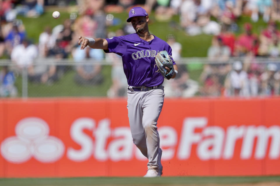 Colorado Rockies' Ezequiel Tovar throws out Los Angeles Angels' Miguel Sano during the second inning of a spring training baseball game, Friday, March 8, 2024, in Tempe, Ariz. (AP Photo/Matt York)