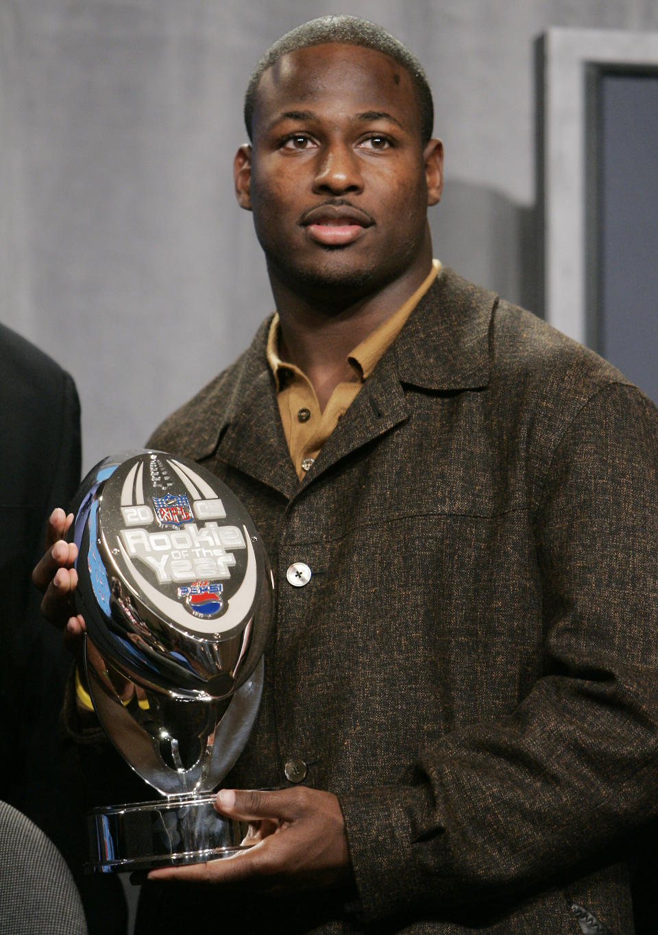 FILE - Tampa Bay Buccaneers running back Carnell "Cadillac" Williams holds his Rookie of the Year trophy during a press conference in Detroit, Thursday, Feb. 2, 2006. Carnell Williams was an All-American running back on Auburn's undefeated team in 2004. Now, the former NFL rookie of the year is running the show. Williams is serving as Auburn's interim coach for the last four games, starting Saturday at Mississippi State. He replaces Bryan Harsin, who was fired Monday, Oct. 31, 2022, after going 9-12 with the Tigers. (AP Photo/Paul Sancya, File)