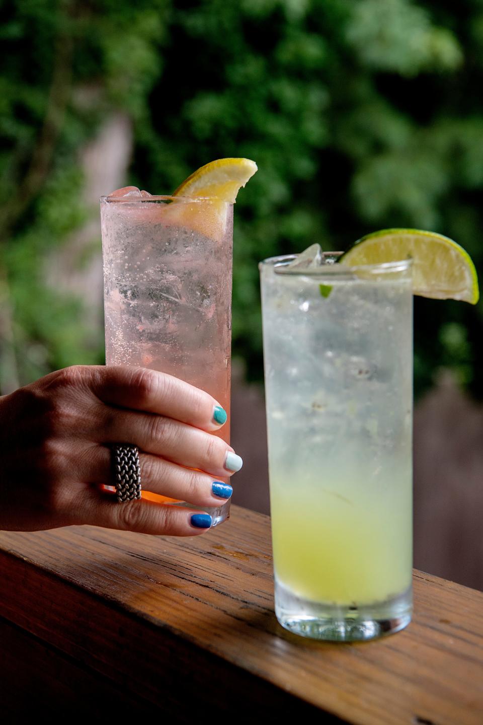 A Lemonade Glow Up cocktail with UpCountry gin, strawberry, basil, lemon, simple syrup and club soda, left, and a Let's Have A Kiwi Mojito with UpCountry rum, kiwi, mint, lime, simple syrup and club soda.