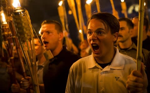 Neo Nazis, Alt-Right, and White Supremacists encircle and chant at counter protestors at the base of a statue of Thomas Jefferson after marching through the University of Virginia campus with torches in Charlottesville, Va., USA on August 11, 2017. - Credit: Anadolu Agency 