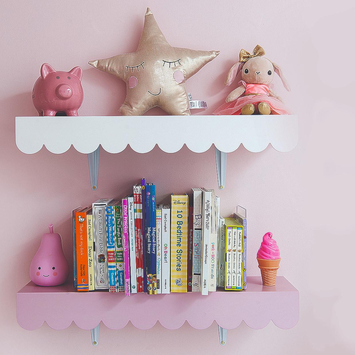  Two shelves in a kid's room with a scalloped trim. 