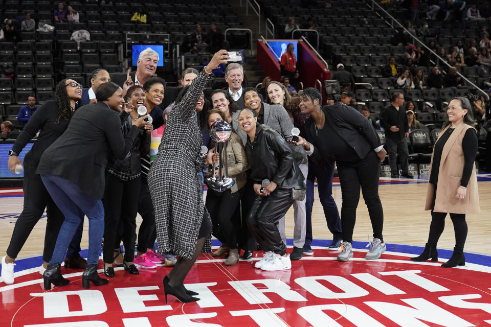 Swin Cash, a member of the 2003 Detroit Shock women's basketball team takes a selfie after the team was honored during halftime of an NBA basketball game between the Detroit Pistons and the Charlotte Hornets, Thursday, March 9, 2023, in Detroit. (AP Photo/Carlos Osorio)