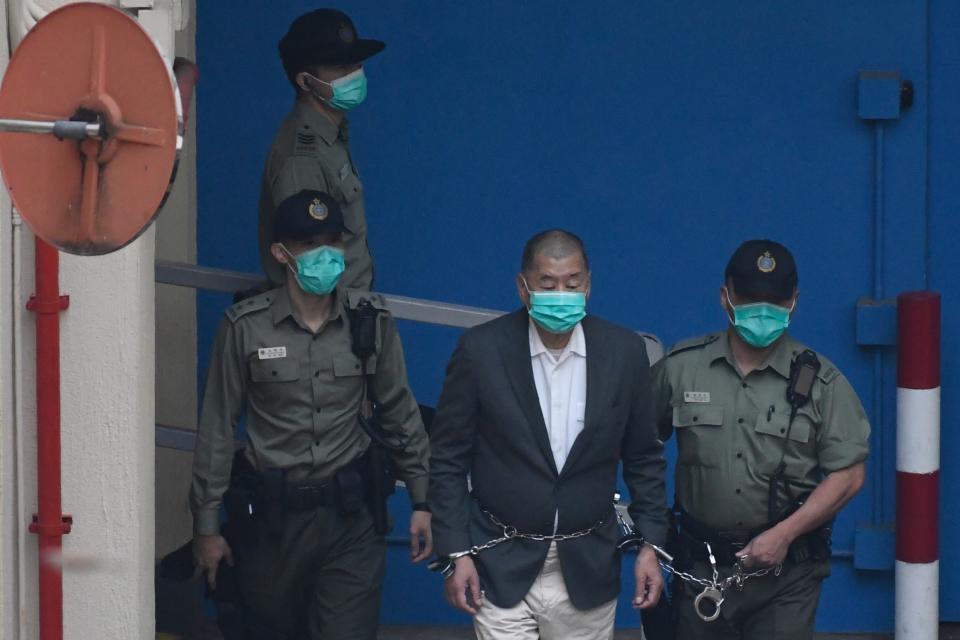 Owner of Apple Daily Newspaper Jimmy Lai is seen shackled as prison guards escort him to a prison van at Lai Chi Kok Reception Center on December 12, 2020 in Hong Kong, China. Jimmy Lai is set to appear before a court in Hong Kong today on Charges under the newly implemented National Security Law. (Photo by Vernon Yuen/NurPhoto via Getty Images)
