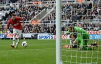 Manchester United's Juan Mata (L) shoots to score his second goal during their English Premier League soccer match against Newcastle United at St James' Park in Newcastle, northern England, April 5, 2014. REUTERS/Nigel Roddis (BRITAIN - Tags: SPORT SOCCER) FOR EDITORIAL USE ONLY. NOT FOR SALE FOR MARKETING OR ADVERTISING CAMPAIGNS. NO USE WITH UNAUTHORIZED AUDIO, VIDEO, DATA, FIXTURE LISTS, CLUB/LEAGUE LOGOS OR "LIVE" SERVICES. ONLINE IN-MATCH USE LIMITED TO 45 IMAGES, NO VIDEO EMULATION. NO USE IN BETTING, GAMES OR SINGLE CLUB/LEAGUE/PLAYER PUBLICATIONS