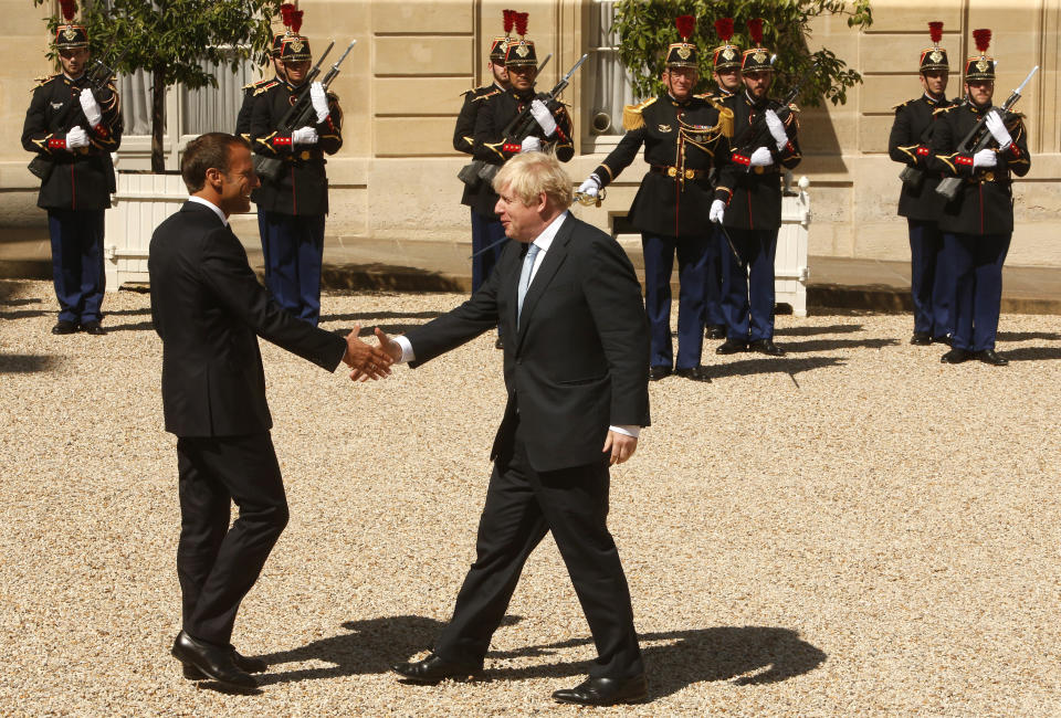 French President Emmanuel Macron, left, welcomes Britain's Prime Minister Boris Johnson at the Elysee Palace, Thursday, Aug. 22, 2019 in Paris. Boris Johnson traveled to Berlin Wednesday to meet with Chancellor Angela Merkel before heading to Paris to meet with French President Emmanuel Macron. (AP Photo/Michel Spingler)