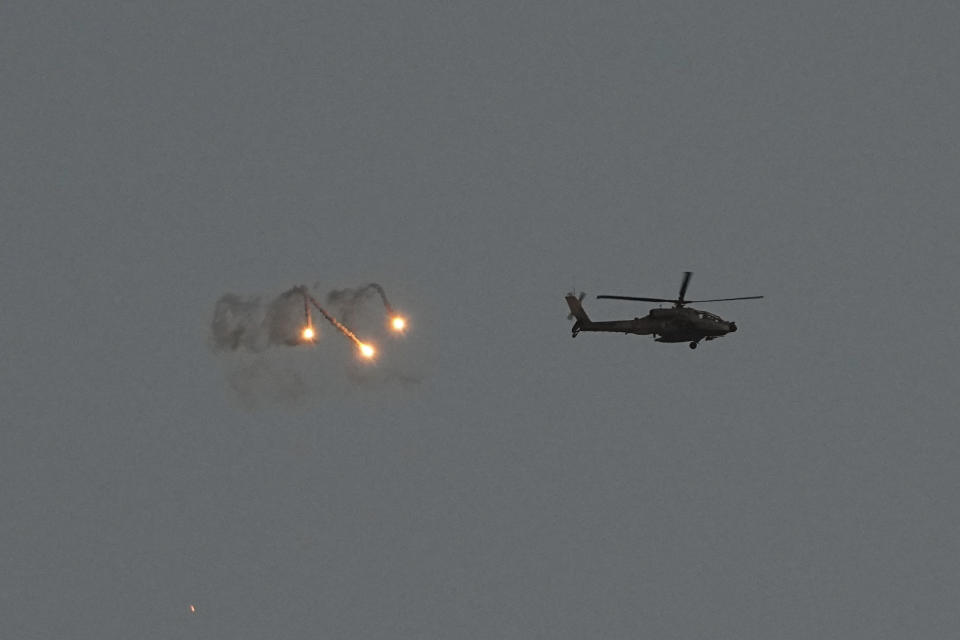 An Israeli Apache helicopter fires flares over the Gaza Strip as seen from southern Israel, Monday, March 4, 2024. The army is battling Palestinian militants across Gaza in the war ignited by Hamas' Oct. 7 attack into Israel. (AP Photo/Ohad Zwigenberg)