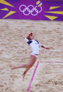 LONDON, ENGLAND - JULY 29: April Ross of the United States serves during Women's Beach Volleyball Preliminary match between the United States and Argentina on Day 2 of the London 2012 Olympic Games at Horse Guards Parade on July 29, 2012 in London, England. (Photo by Ryan Pierse/Getty Images)