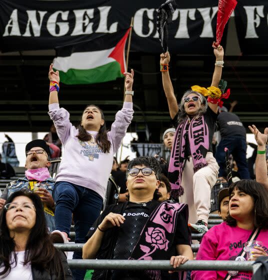 LOS ANGELES, CA - JUNE 5, 2023: Gaby Alcala of Boyle Heights, top right, cheers with other fans for Angel City FC as they play the Chicago Red Stars in a Women's Professional Soccer match at BMO Stadium on June 5, 2023 in Los Angeles, California. (Gina Ferazzi / Los Angeles Times)