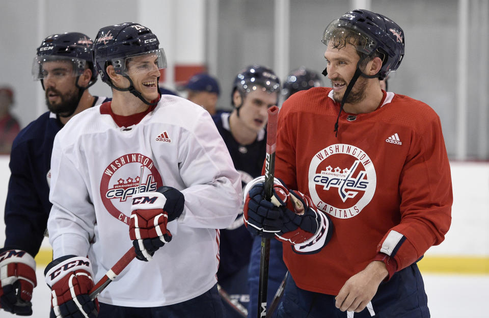 Washington Capitals left wing Alex Ovechkin, right, of Russia, laughs with Nic Dowd, left, as they leave the ice at NHL hockey training camp, Friday, Sept. 14, 2018, in Arlington, Va. (AP Photo/Nick Wass)