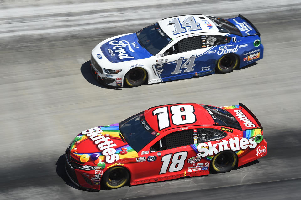 BRISTOL, TENNESSEE - MAY 31: Kyle Busch, driver of the #18 Skittles Toyota, leads Clint Bowyer, driver of the #14 Built Ford Proud Ford, during the NASCAR Cup Series Food City presents the Supermarket Heroes 500 at Bristol Motor Speedway on May 31, 2020 in Bristol, Tennessee. (Photo by Jared C. Tilton/Getty Images)