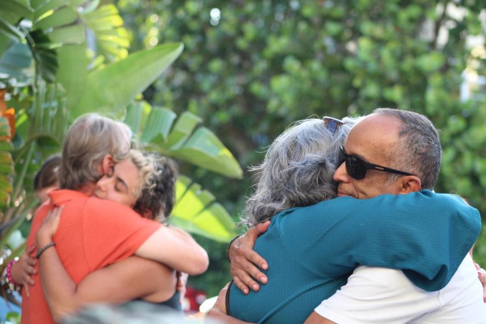 Ana Van Gilst, mother of slain Andrea Doria Dos Passos, and her husband Victor Van Gilst hug community members who attended a vigil for her daughter on Thursday, April 25, 2024.