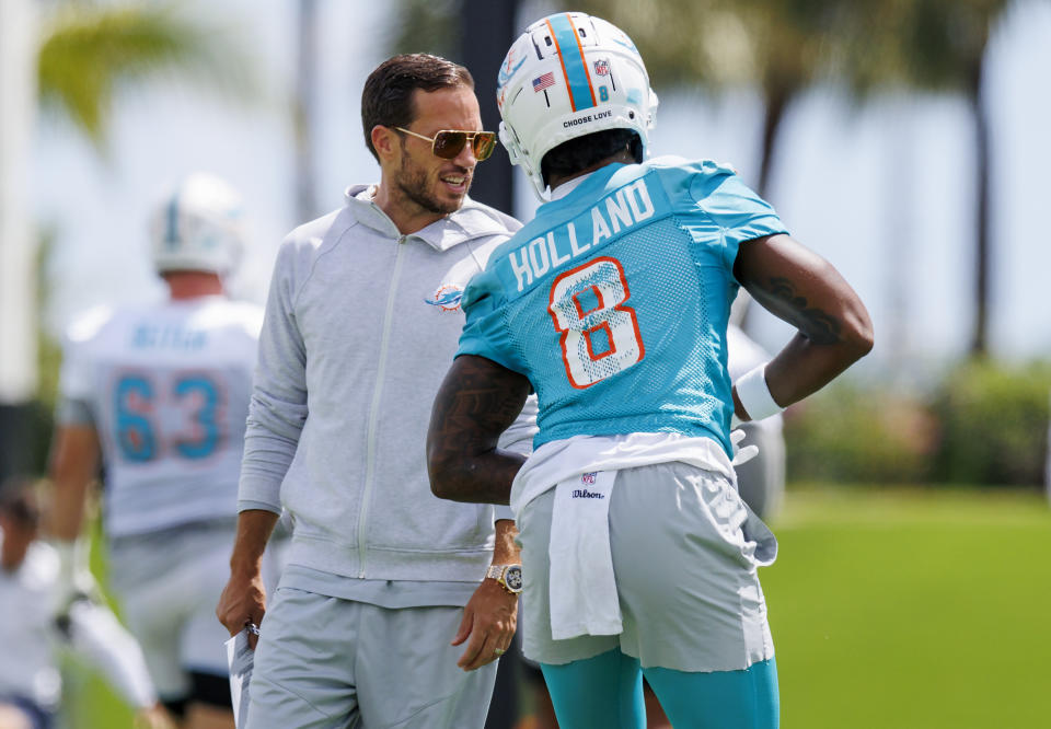Miami Dolphins head coach Mike McDaniel talks with Dolphins safety Jevon Holland (8) during NFL football training camp at Baptist Health Training Complex in Hard Rock Stadium on Monday, Sept. 5, 2022 in Miami Gardens, Fla. (David Santiago/Miami Herald via AP)