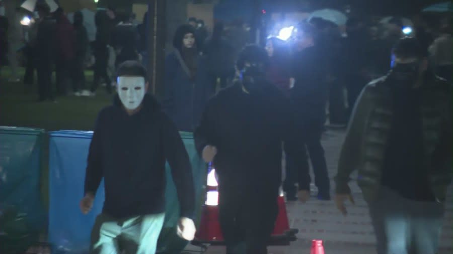 Many people in white masks showed up before violence broke out among pro-Palestinian and pro-Israel protestors at the UCLA campus on April 30, 2024. (KTLA)