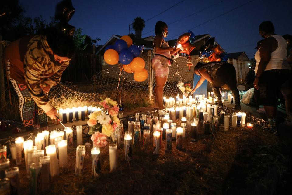 People gather and light candles at a makeshift memorial where Dijon Kizzee, a 29-year-old Black man, was killed by Los Angeles sheriff's deputies in South Los Angeles on September 1, 2020 in Los Angeles, California. Protesters marched to the South Los Angeles Sheriffs' Station to demonstrate for a second day after Kizzee was killed in an altercation after being stopped by police while riding his bicycle.