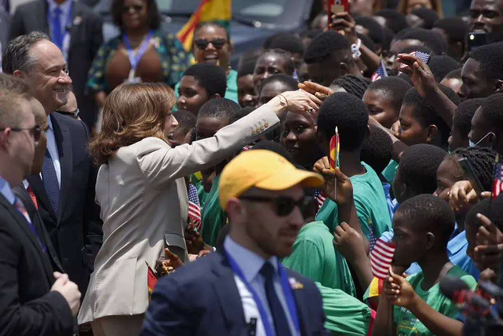 U.S. Vice President Kamala Harris greets school children during her arrival ceremony at Kotoka International Airport in Accra, Ghana Sunday, March 26, 2023. (AP Photo/Misper Apawu)