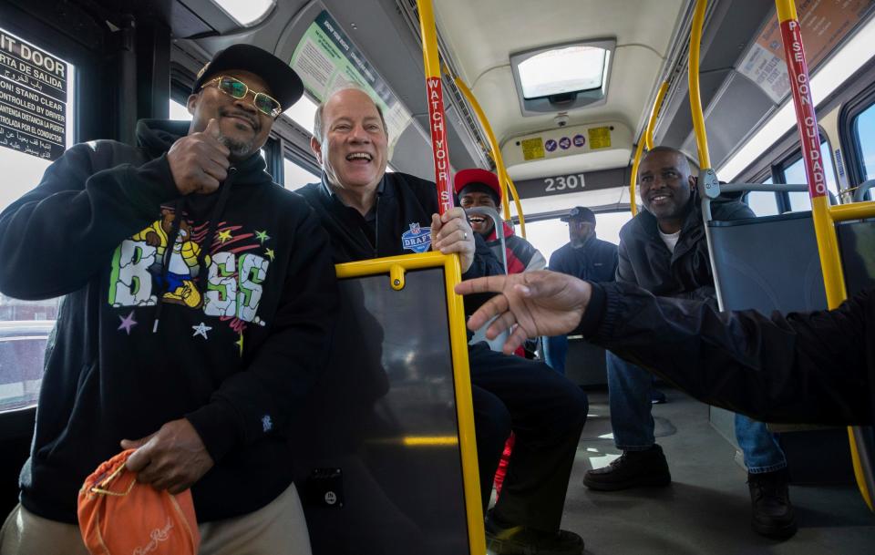 Mayor Mike Duggan smiles as he takes a photo with a passenger inside a bus heading to the Detroit Department of Transportation's new transit center, the Jason Hargrove Transit Center, at the State Fairgrounds in Detroit on Saturday, May 11, 2024.