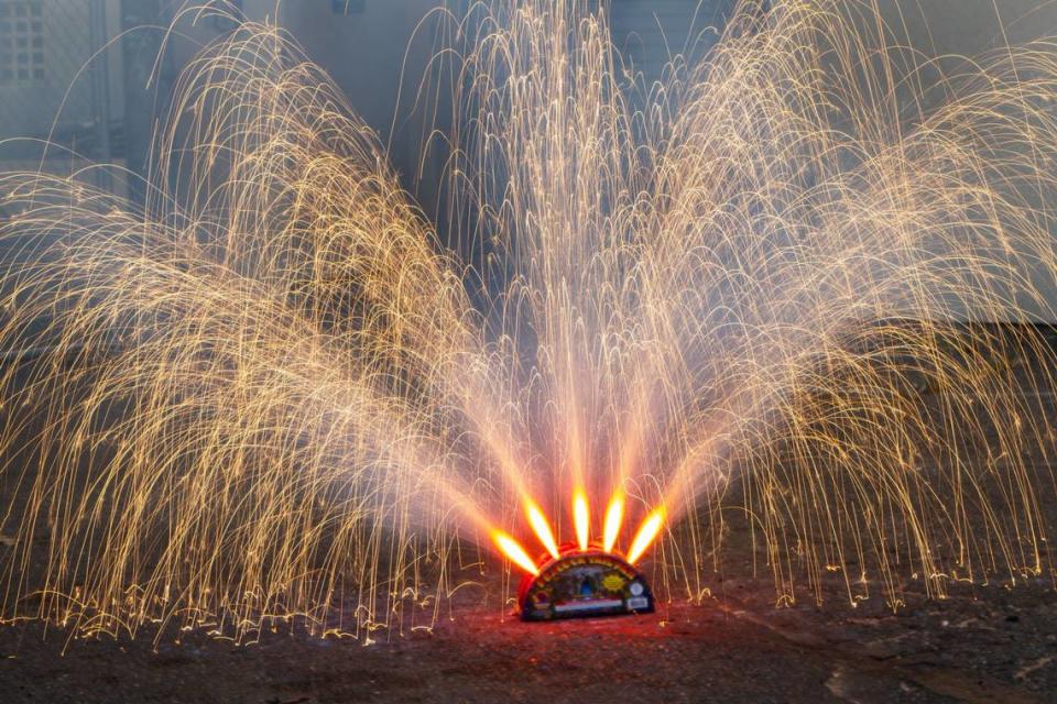 Phantom Fireworks’ Peacock Tail Fan fountain spews red light on Monday, June 24, 2024, at Sacramento Fire Department Station 4 in Sacramento. The Sacramento Bee’s interns gave this fountain a rating of 4.66 out of five total points.