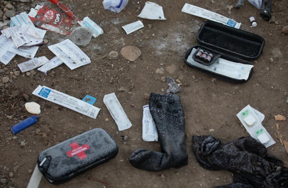 Naloxone kits lie on the ground as police and cleanup crews tear down homeless encampments in Edmonton on Friday, December 29, 2023.