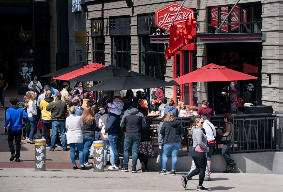 Customers line up outside Hattie B's Hot Chicken at 5th and Broadway Sunday, March 27, 2022 in Nashville, Tenn. 