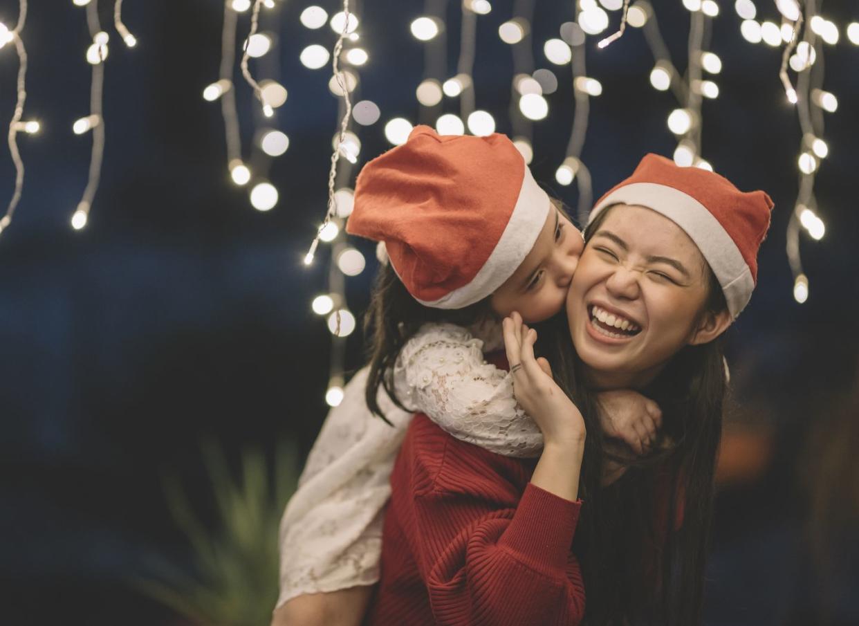 girls wearing santa hats laughing