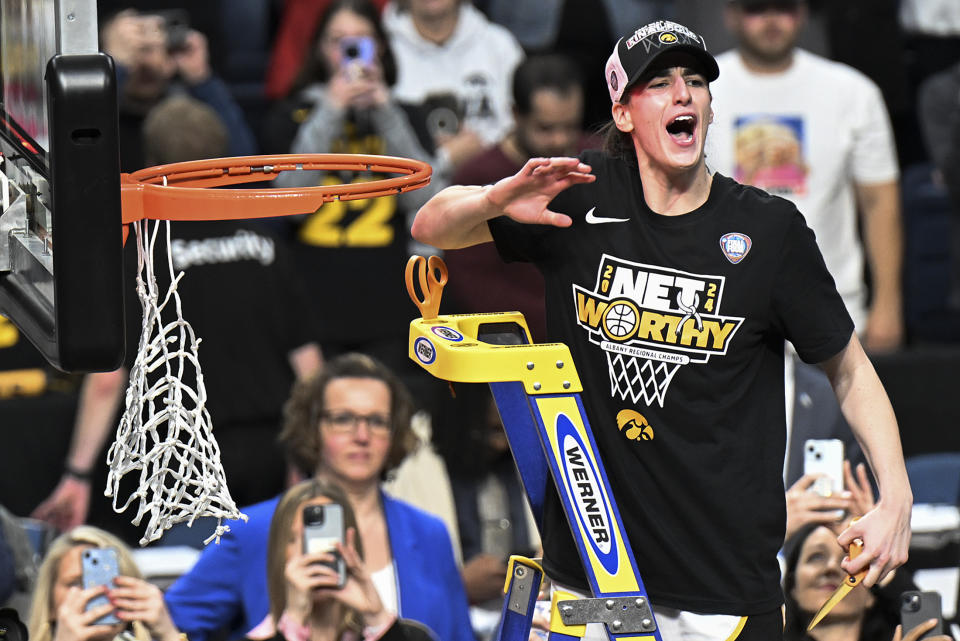 Iowa guard Caitlin Clark reacts to the crowd before cutting a piece of the net after Iowa defeated LSU in an Elite Eight round college basketball game during the NCAA Tournament, Monday, April 1, 2024, in Albany, N.Y. (AP Photo/Hans Pennink)