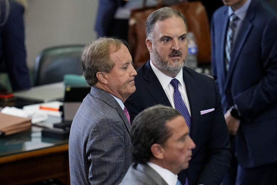 Suspended Texas state Attorney General Ken Paxton, center, stands with his attorneys Tony Buzbee, front, and Mitch Little, rear as his impeachment trial continues in the Senate Chamber at the Texas Capitol, Friday, Sept. 15, 2023, in Austin, Texas. (AP Photo/Eric Gay)