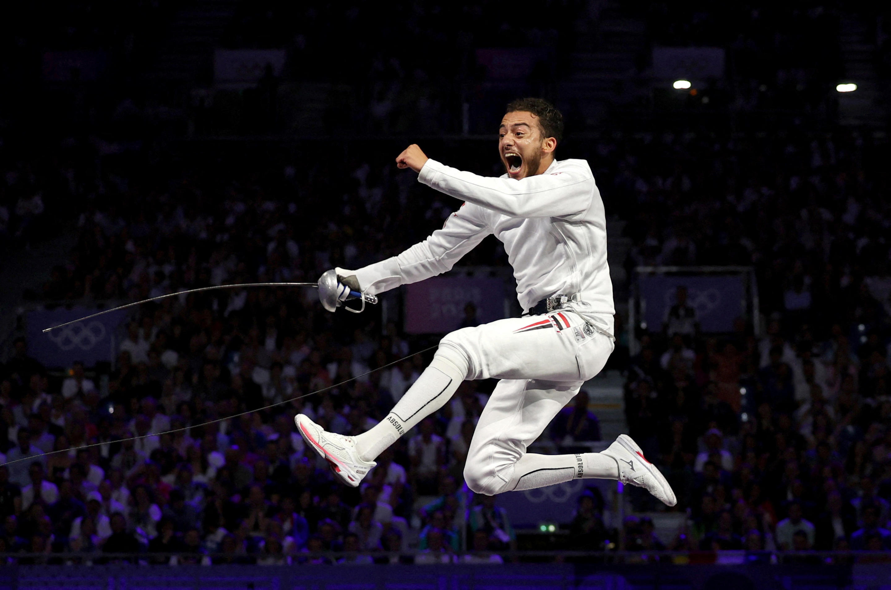 Fencer Mohamed Elsayed of Egypt leaps in celebration after winning his bronze medal in men's epee individual.