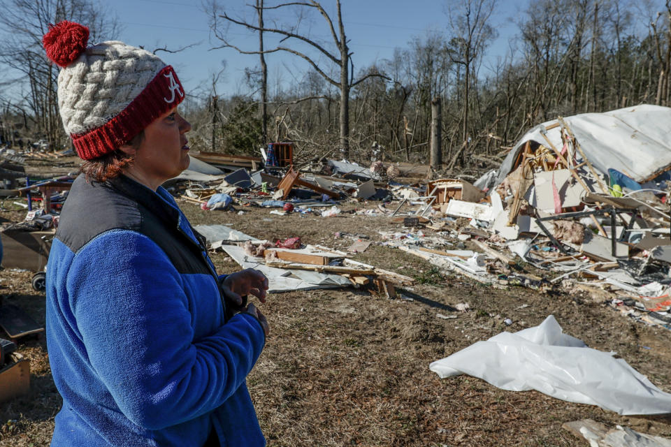 Leighea Johnson looks over what is left of her home after a tornado that ripped through Central Alabama earlier this week destroying her home on Saturday, Jan. 14, 2023 in Marbury, Ala. Her daughter and grandson where in the home and survived with minor injuries. (AP Photo/Butch Dill)