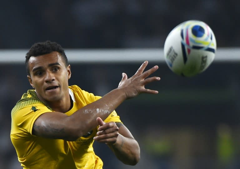 Australia's scrum half Will Genia passes the ball during a Pool A match of the 2015 Rugby World Cup between England and Australia at Twickenham stadium, south west London, on October 3, 2015