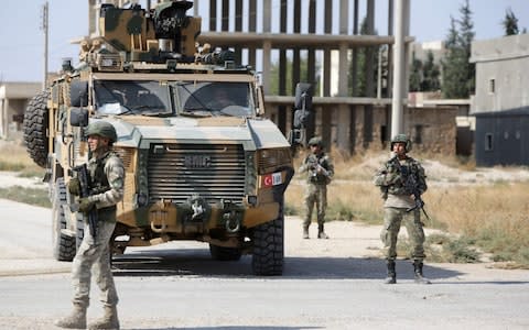 Turkish soldiers patrol the northern Syrian Kurdish-held town of Tal Abyad, on the border between Syria and Turkey - Credit: AFP