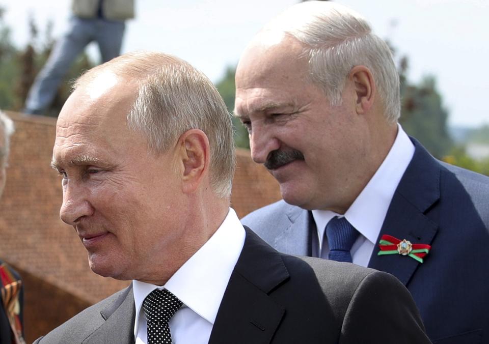 FILE - In this June 30, 2020, file photo, Russian President Vladimir Putin, left, and Belarusian President Alexander Lukashenko greet World War II veterans during the opening of a monument in their honor in the village of Khoroshevo, northwest of Moscow, Russia. Lukashenko is beset by protests since his Aug. 9 reelection in a vote that the opposition says was fraudulent. (Mikhail Klimentyev, Sputnik, Kremlin Pool Photo via AP, File)