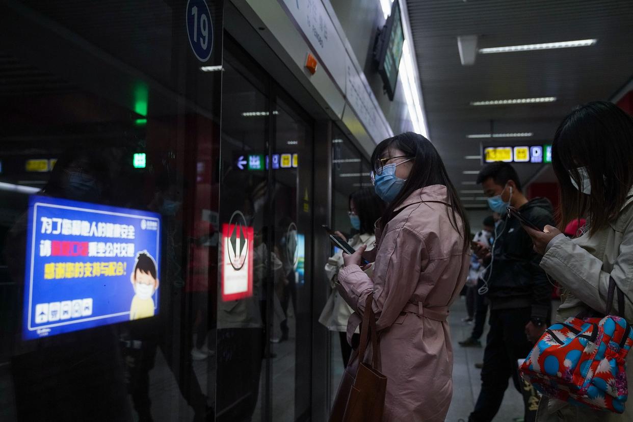 Commuters wear protective masks as they exit a train at a subway station during rush hour on April 20, 2020, in Beijing, China. Life in Beijing is slowly returning to normal following a city-wide lockdown on Jan. 25 to contain the coronavirus (COVID-19) outbreak.