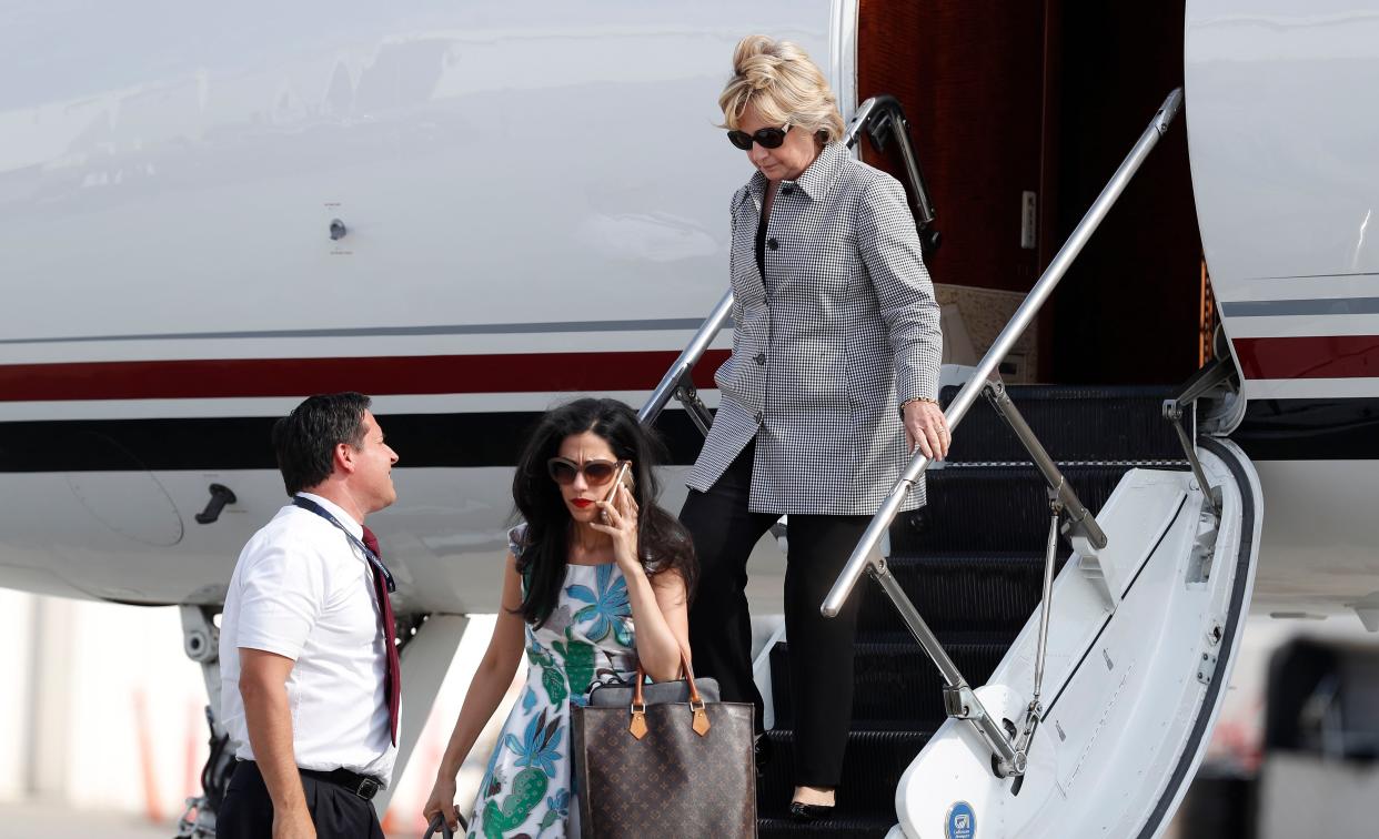 Former Secretary of State Hillary Clinton (top right) and Huma Abedin, lower left on cell phone.