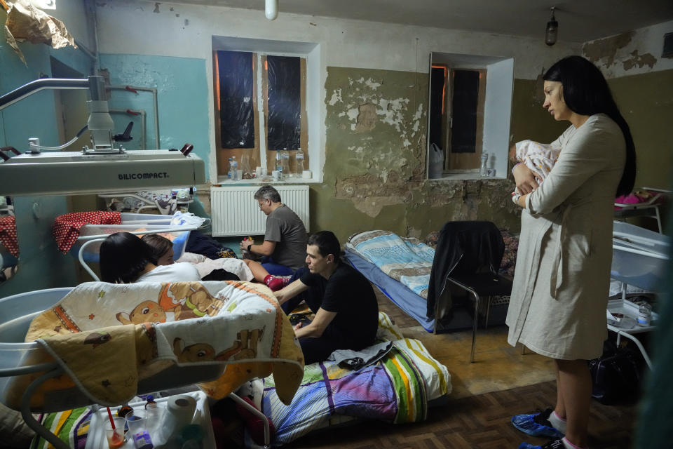 A woman holds her newborn child in a maternity hospital’s basement used as a bomb shelter during an air raid alert in Kyiv, Ukraine, Wednesday, March 2, 2022. (AP Photo/Efrem Lukatsky)