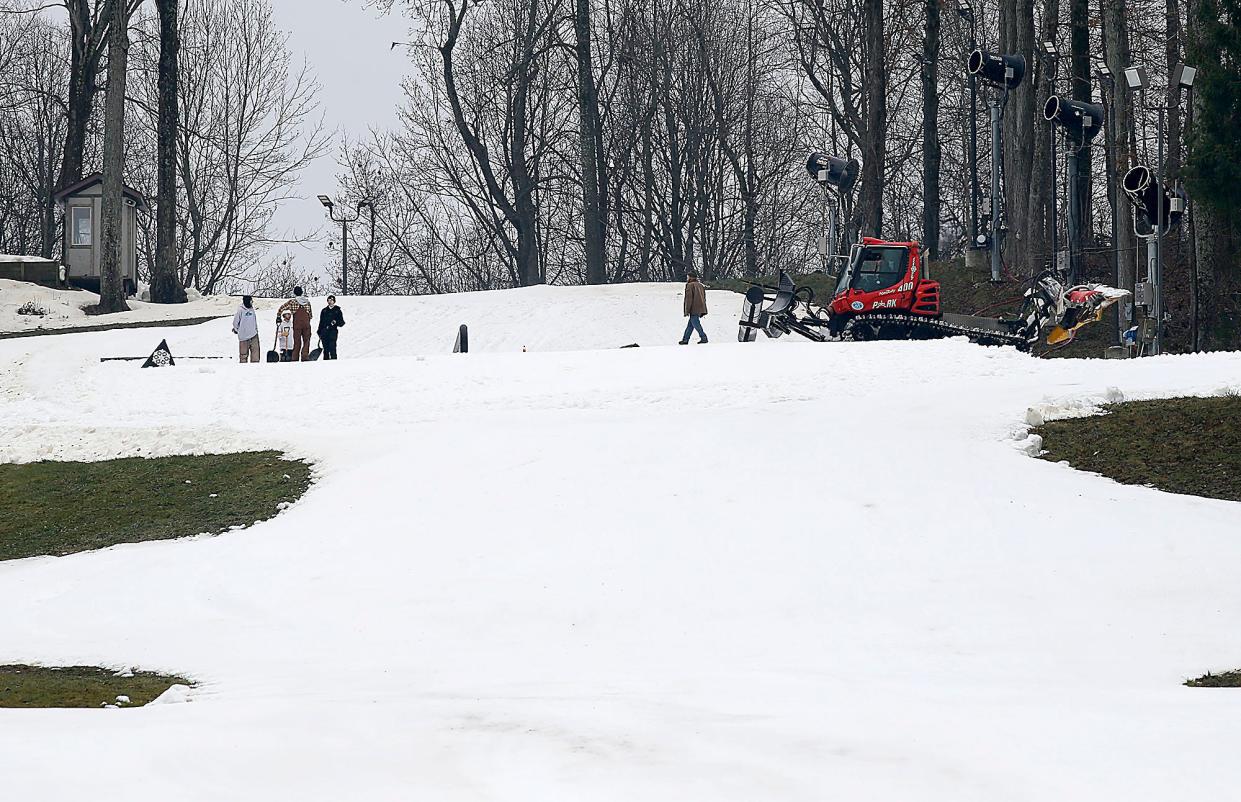 Snow Trails employees work Thursday to get the slopes in condition for their opening on Friday.