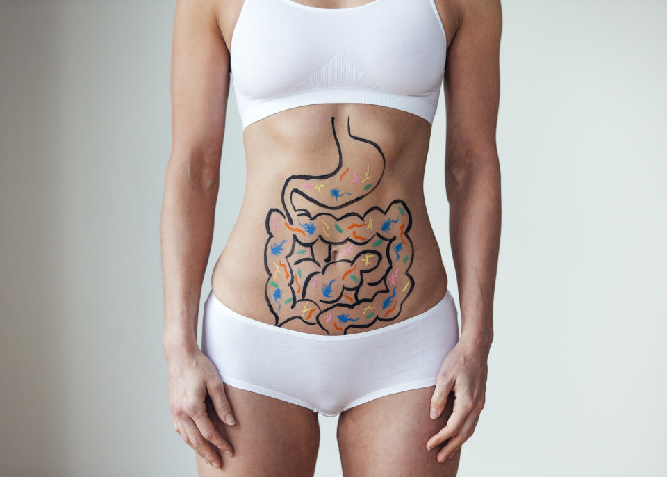 Female with an illustration on her abdomen of intestines with colourful bacteria