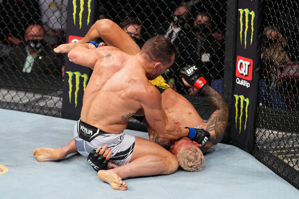 HOUSTON, TEXAS - MAY 15: (L-R) Michael Chandler punches Charles Oliveira of Brazil in their UFC lightweight championship bout at Toyota Center on May 15, 2021 in Houston, Texas. (Photo by Josh Hedges/Zuffa LLC)