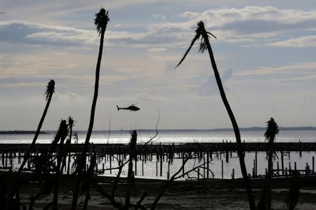 FILE PHOTO: An unidentified helicopter lands to deliver food and water in the aftermath of Hurricane Dorian in Marsh Harbour