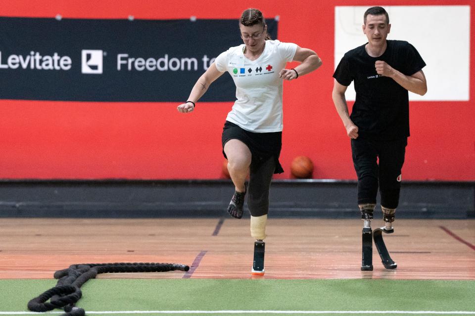 Jacky Skubic (center) and Kyle Ferris during a tryout day for Levitate prostheses at D1 Training in Upper Saddle River on Saturday, April 22.