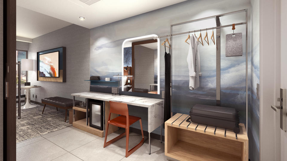 The “Get Ready Zone” in each room is a dedicated space for guests to prepare for their day with a lit vanity and storage keep their belongings organized. Rendering by: Hilton.