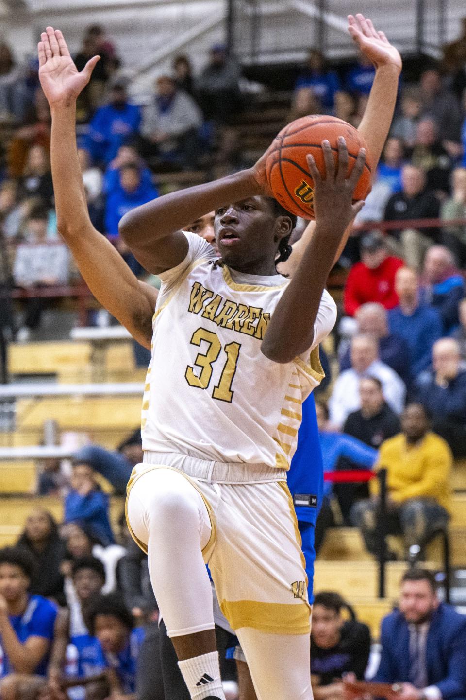 Warren Central High School freshman James Craig (31) fires off a pass from under the basket during the first half of a Boysâ€™ Marion County Basketball Tournament semi-final game against Franklin Central High School, Friday, Jan. 12, 2024, at Southport High School.