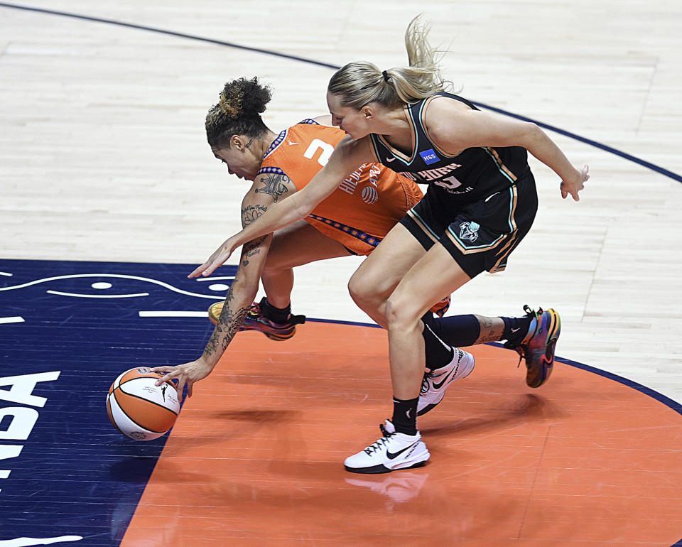 Connecticut Sun's Natisha Hiedeman (2) and New York Liberty's Marine Johannes (23) vie for the ball during a WNBA basketball game Thursday, Aug. 24, 2023, in Uncasville, Conn. (Sarah Gordon/The Day via AP)