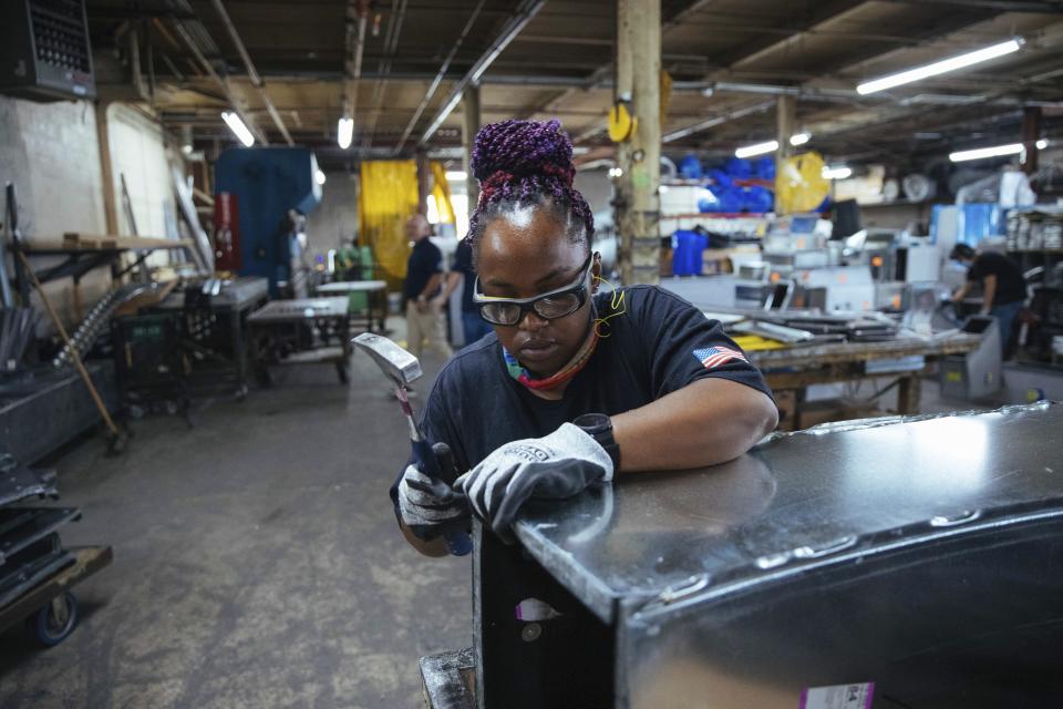 Sheet metal worker Carey Mercer assembles ductwork at Contractors Sheet Metal on Tuesday, Aug. 3, 2021, in New York. The construction industry is fighting to recruit more women into a sector that faces chronic labor shortages. Women make up only 4% of skilled construction laborers in the U.S. and often face discrimination on jobs sites. (AP Photo/Kevin Hagen)